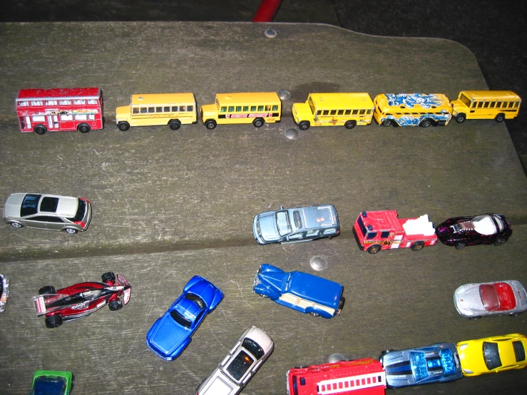 a large set of different toy cars are lined up