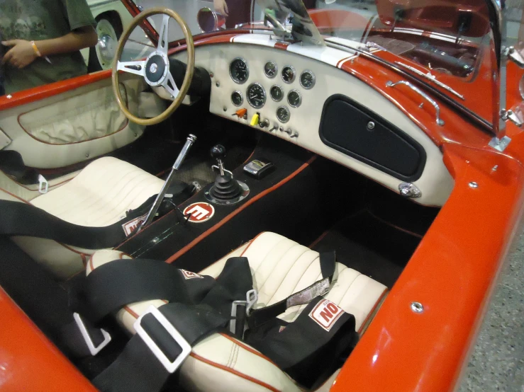 the interior of a red vintage sports car