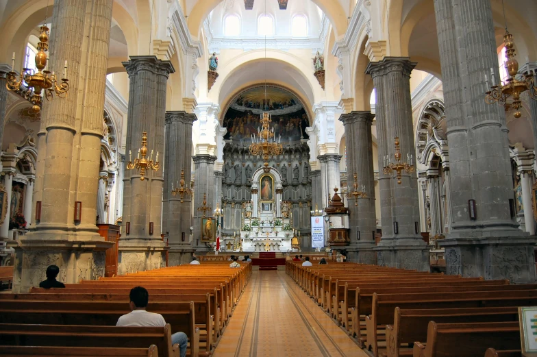 an empty church with wooden pews in it