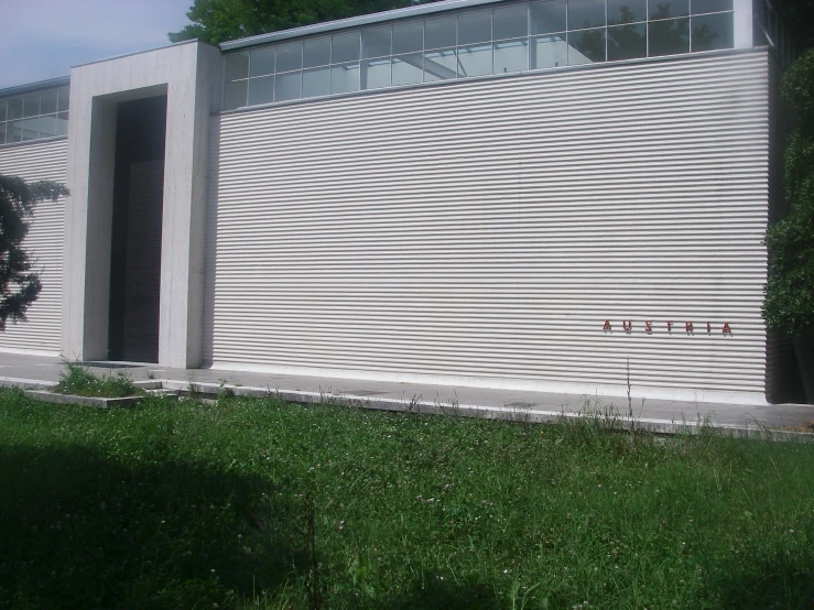 the side of a building is closed and there are red signs in front of it