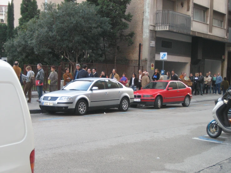 several cars parked in the street by some buildings