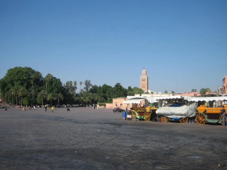 colorful carriages near a city square surrounded by tall buildings