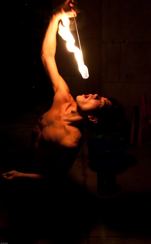 a  man in a dark room with an electronic light