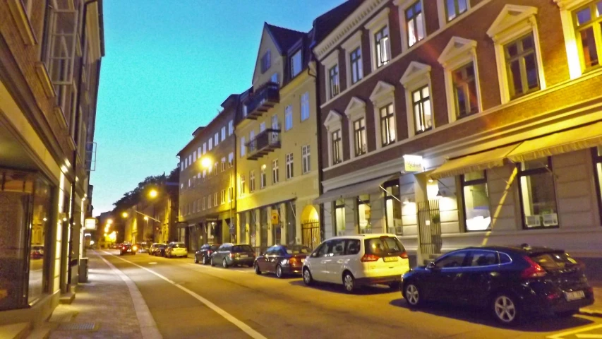 many cars parked on the side of a city street