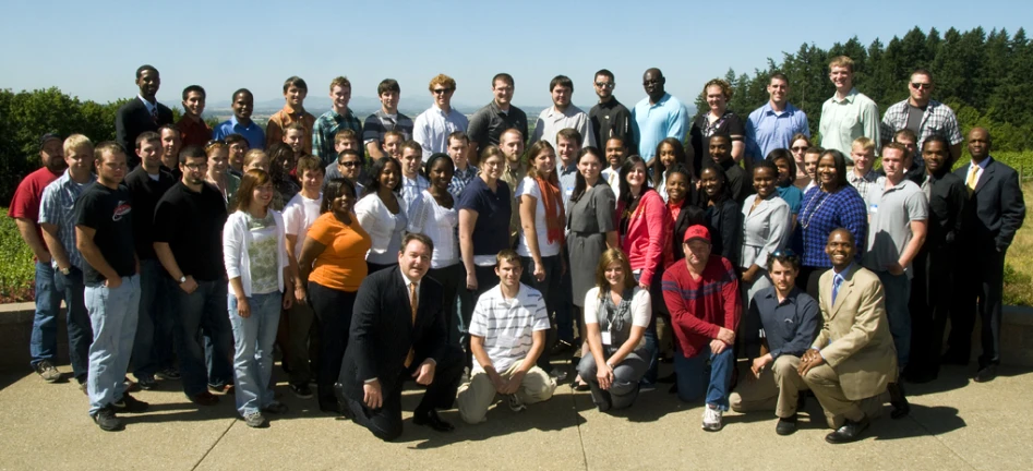 a group of people are posing together outside