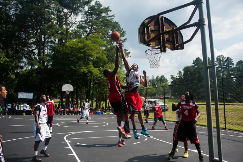 men playing a game of basketball on a court