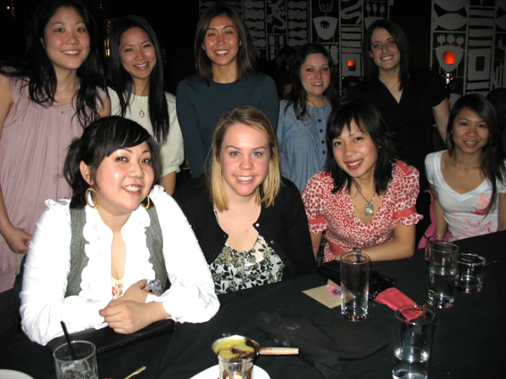 a group of young ladies are posing for the camera