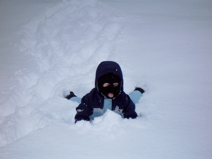 a child laying down in the snow