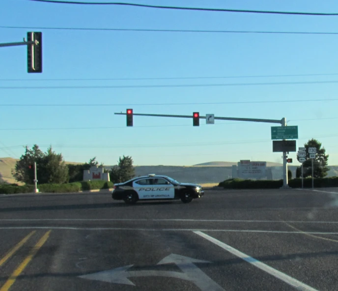 a police car is parked at an intersection