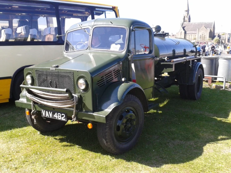 a couple of very old trucks parked next to each other