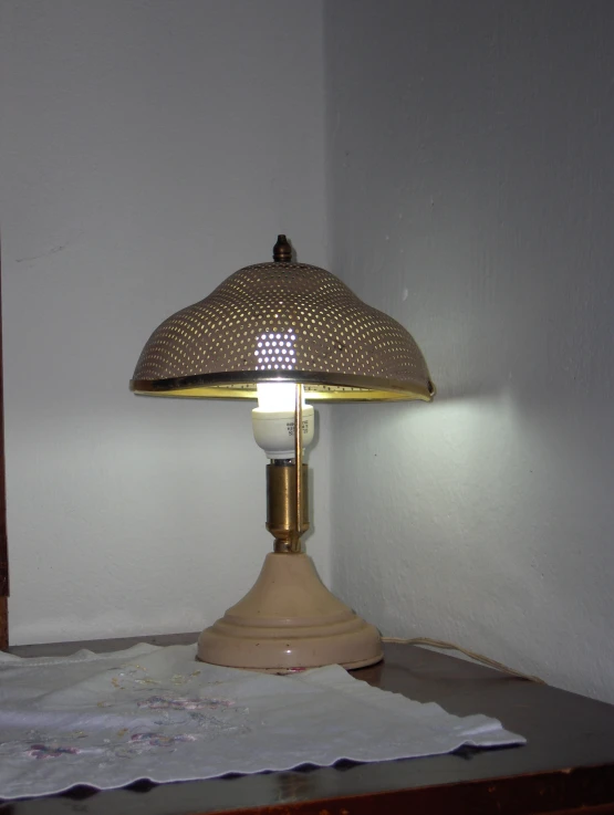 an old fashion lamp is sitting on a table