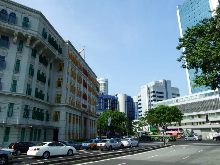 a street view with many cars on it and buildings in the background