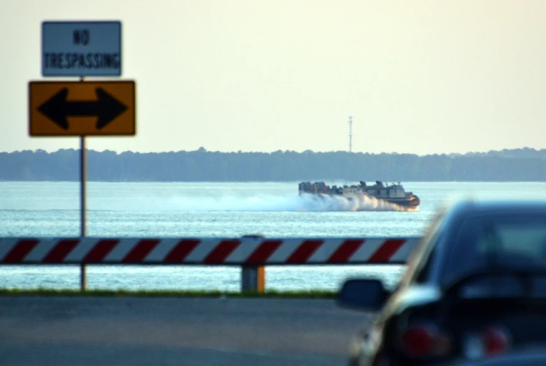 the boat is leaving the water next to traffic signs