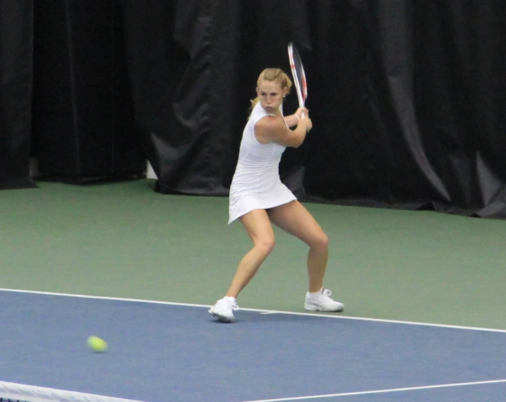 a woman is playing tennis on a court