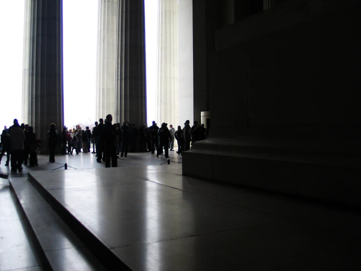 many people are in the shadow in a dark hallway