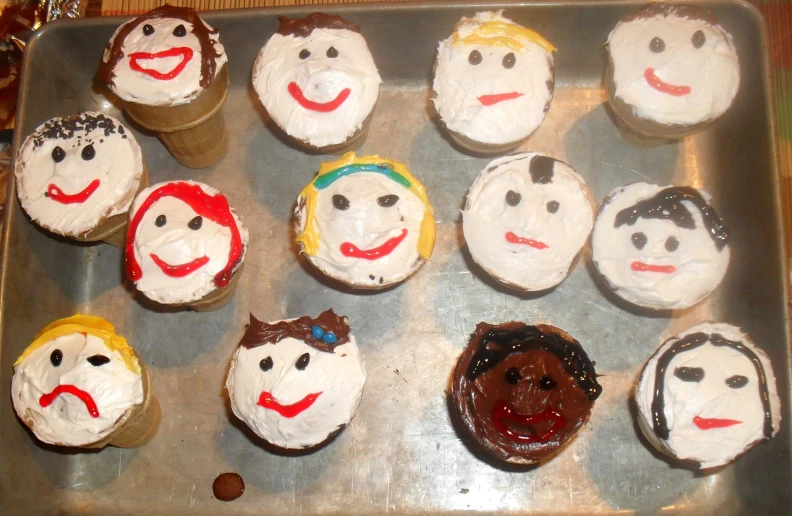 these cupcakes look like people with different faces on them