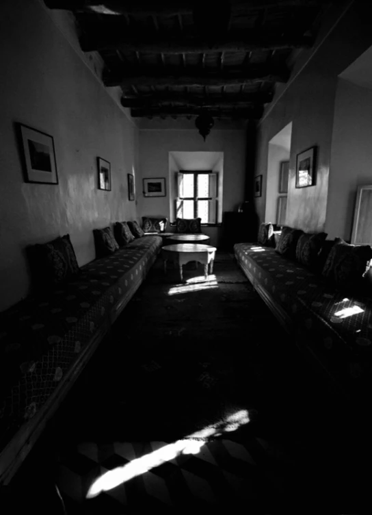 this is a black and white image of a long living room