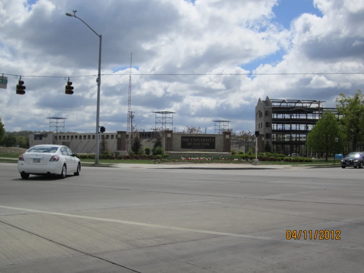 an intersection with a car and traffic lights