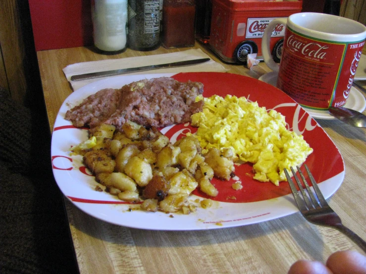 a plate of food with scrambled eggs and sausage