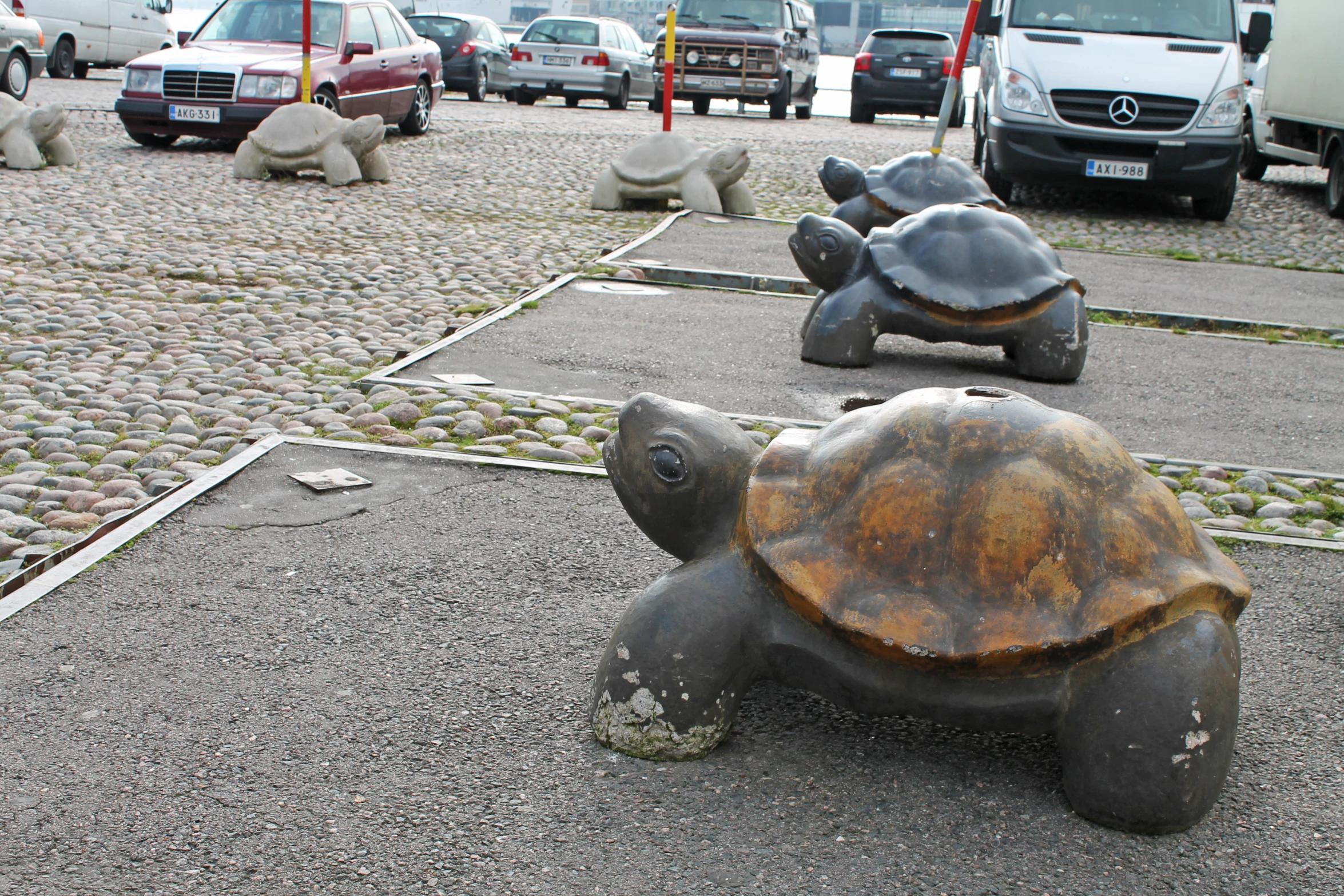 there are sculptures of turtles that are sitting on the side walk