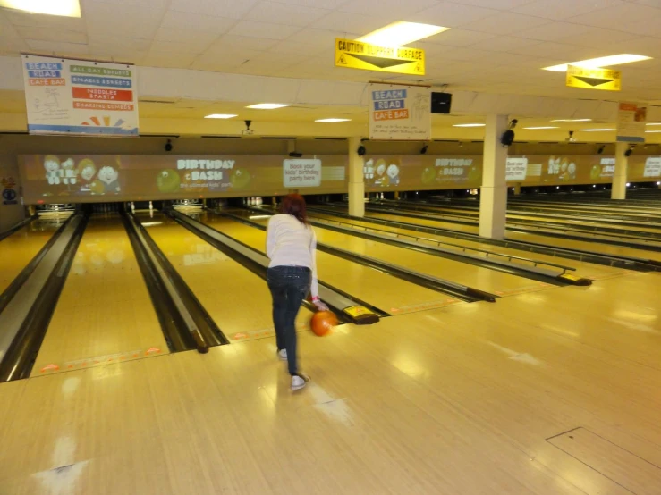 the young man is bowling down the bowling lane