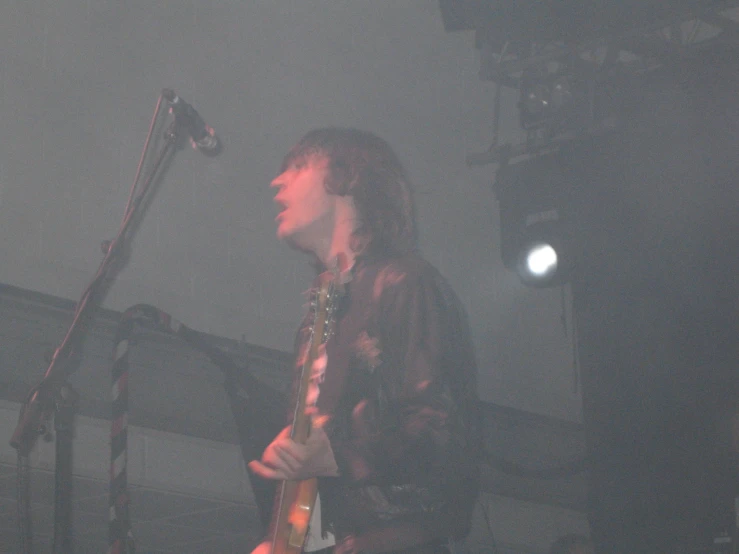 a man playing an electric guitar on stage