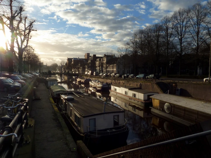 boats are docked on the water in a city canal