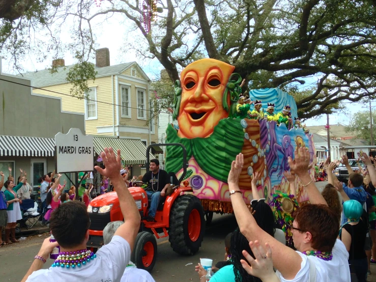 a very big car with some people waving