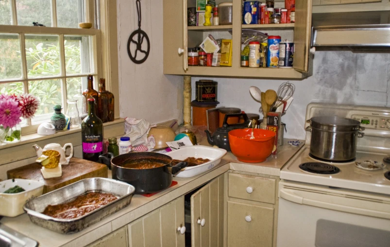 there is a kitchen with several pots, pans and containers