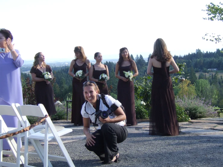 a group of girls on the side of the road in front of their friends