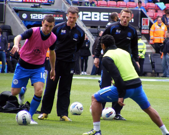 soccer players in a group on a grass field