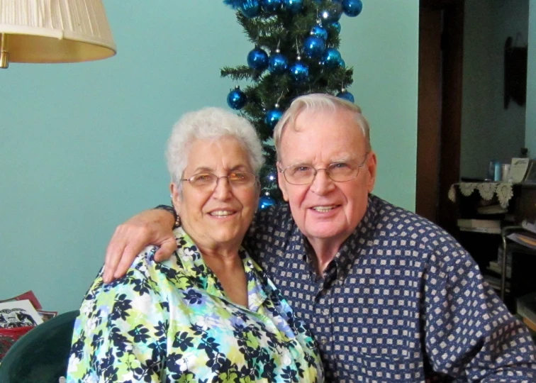 an elderly man and woman emcing each other