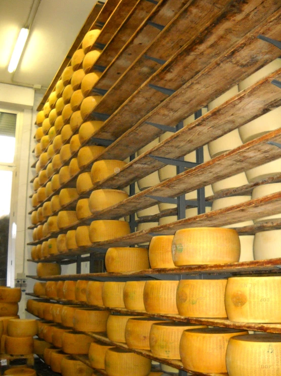 a wall full of cheese stacked on top of each other