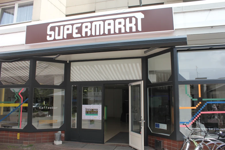 a store front with an advertit saying'supermarket '