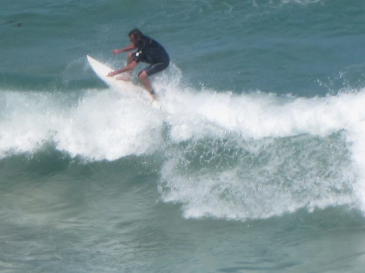 a man is riding a wave on his surfboard