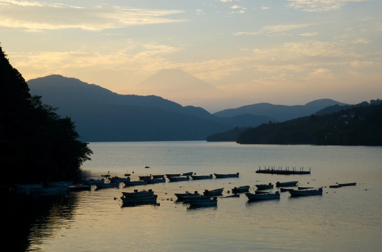 boats sitting in the middle of a large lake