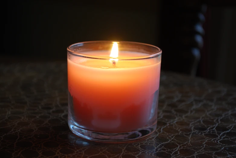 a lit candle is sitting on a table