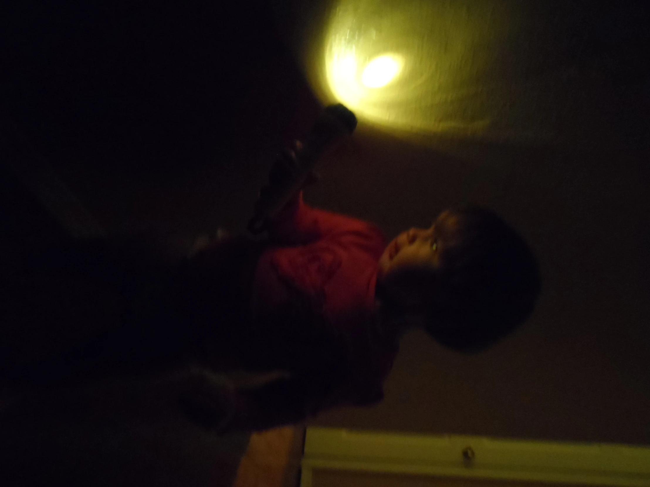 a little boy in the dark holding soing in his hands
