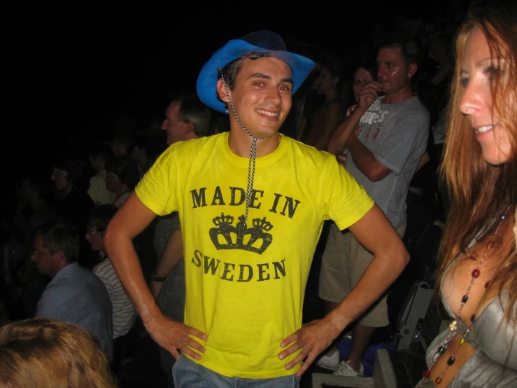 a man in a yellow shirt is standing in front of other people