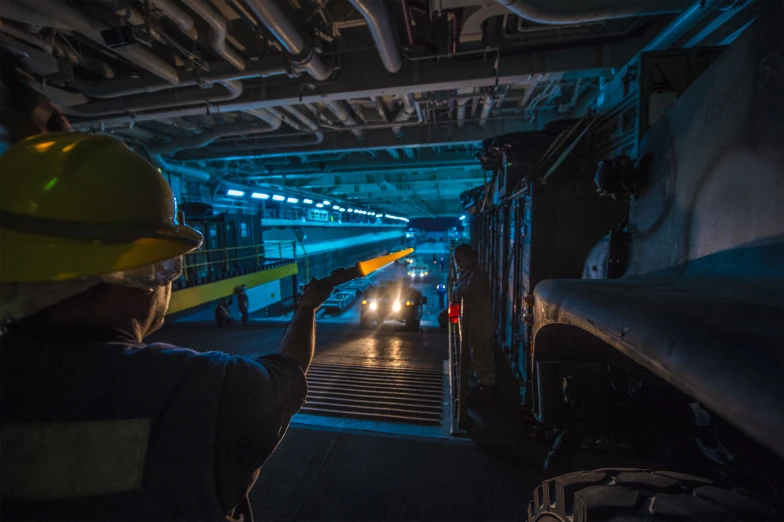 a worker looks up as he prepares to go down the stairs