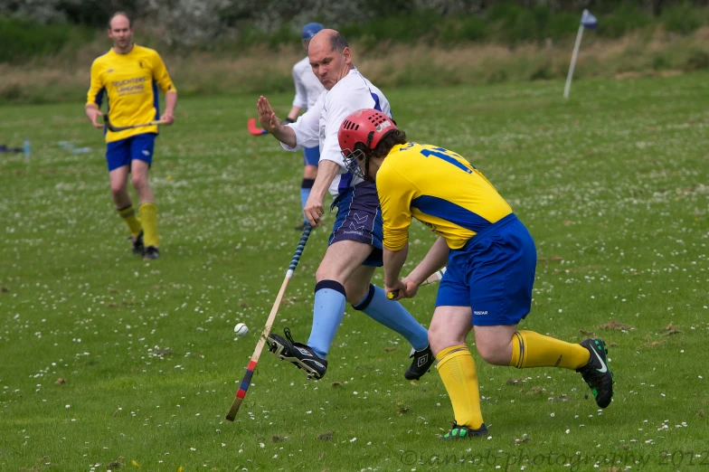 two men on a field playing soccer with each other