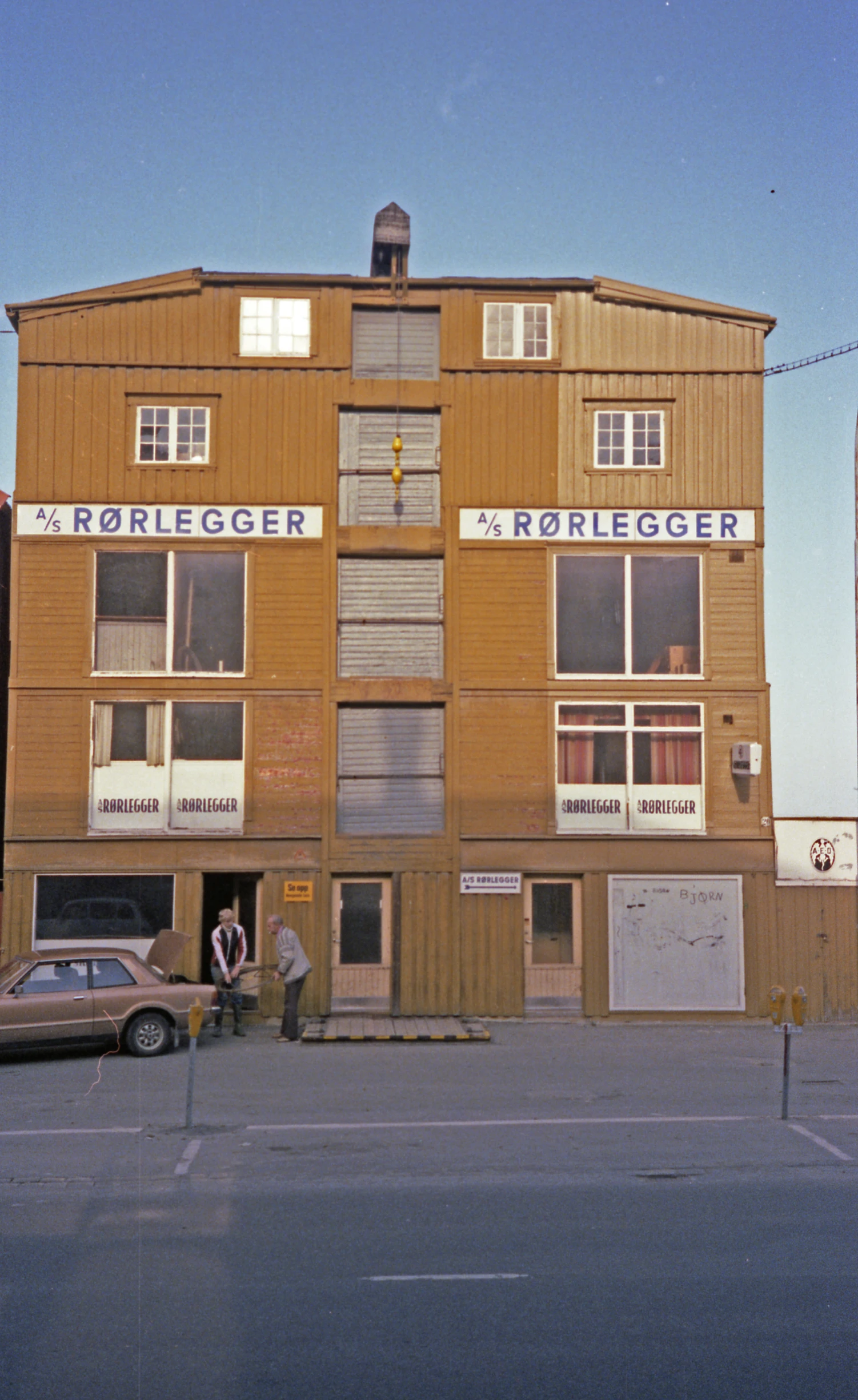 a big building that is very tall with two men standing outside