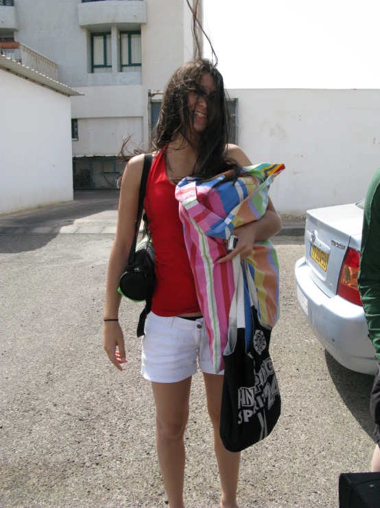 a women who is holding some luggage while walking