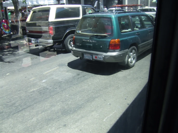a vehicle in the street with it's rear window partially open