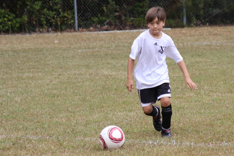 the  in the white shirt is playing soccer