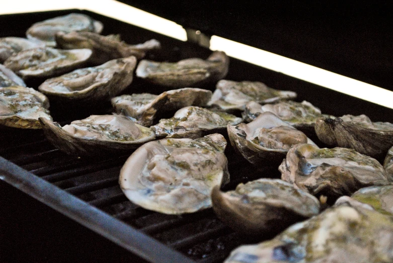 a grill with baked mushrooms on it being cooked