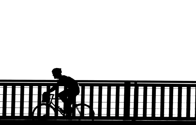 a man in his bike is on a bridge
