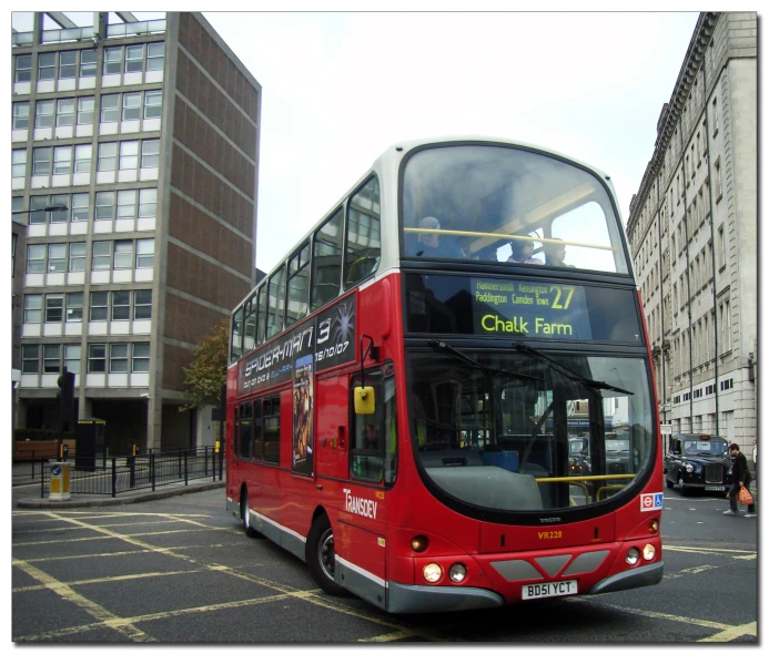 a large red bus traveling down a city street