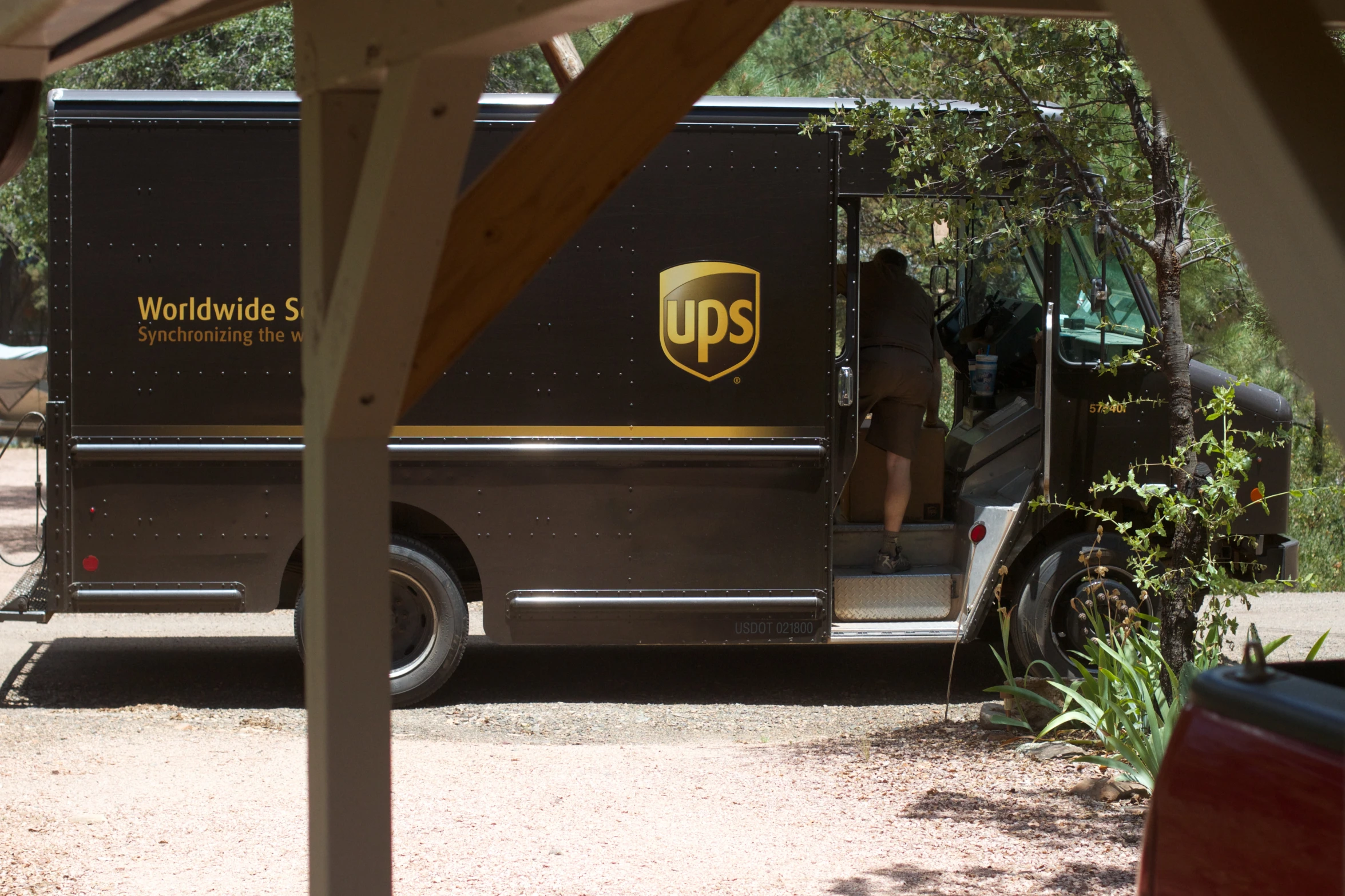 a ups van parked in front of trees