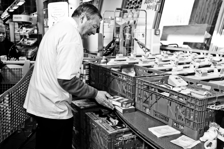 a man standing in a store next to boxes